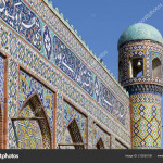 Khan's palace in Kokand. Uzbekistan. Ancient palace with facades of colored mosaic. The main entrance is with minarets. فرغانه مسجد مزین به شعر فارسی